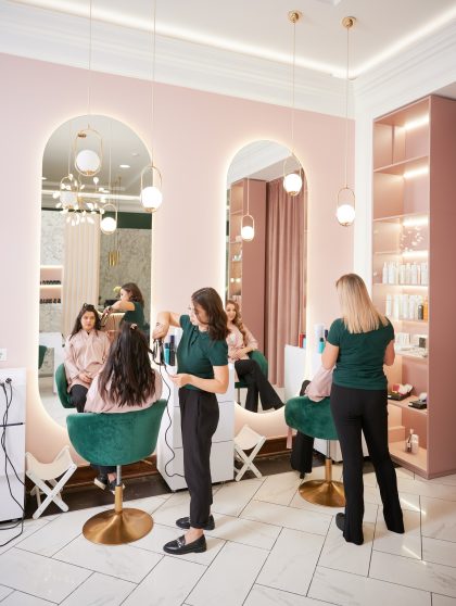 Hairdressers styling women hair in beauty salon. Hairdressers styling women hair in beauty salon.